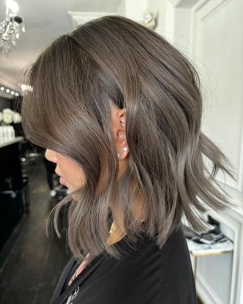 Elevate your fall look with a smoky gray wavy bob, a chic metallic style perfect for the season. This fall haircut offers a cool, contemporary vibe with soft waves and a unique color that stands out in autumn. Ideal for those who love experimenting with hair. Metallic Brown Hair, Ash Brown Hair Ideas, Natural Ash Brown Hair, Ashy Brown Hair Balayage, Silver Ash Hair, Medium Ash Brown Hair, Brown Hair With Silver Highlights, Ashy Brown Hair, Ash Gray Hair Color