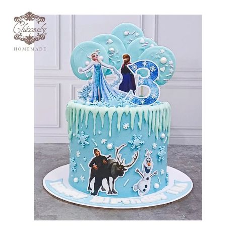 Buttercream Frozen theme birthday cake with Frozen characters cake topper, chocolate drips, and sprinkled chocolate lollypops. Frozen Cake With Topper, Two Tier Frozen Cake Birthday, Frozen Theme Birthday, Frozen Fever Birthday Cake, Frozen Tiered Birthday Cake, Frozen Cake With Figurines, Theme Birthday Cake, Frozen Birthday Theme, Frozen Characters