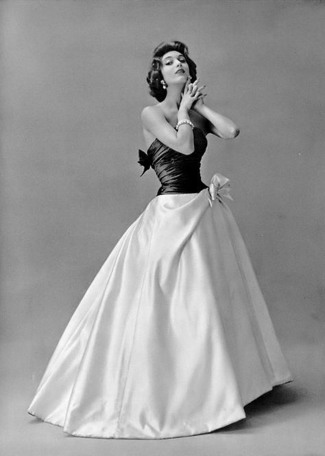 1956 Marie-Hélène in beautiful evening gown of a full white satin skirt topped by a gray draped top that ties in a bow in the back, by Pierre Balmain 1950s Gowns Evening Dresses, 1950s Gown, White Satin Skirt, 1959 Fashion, Drawing Tut, 50s Glamour, Balmain Fashion, Betty Dress, Balmain Collection