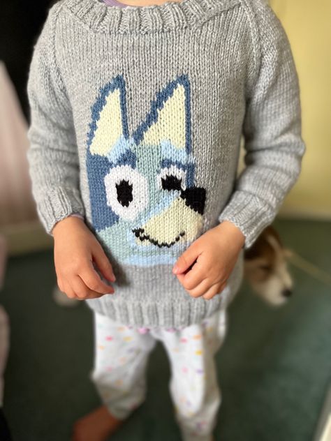 A grey hand knitted jumper with a Bluey head in the middle. Knitting Pattern For Bluey The Dog, Bluey Knitting Pattern Free, Bluey Knitting Pattern, Intarsia Knitting Charts, Cambridge United, Baby Booties Free Pattern, Toddler Patterns, Intarsia Knitting, Hand Knitted Jumpers