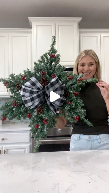 Laura Jeanne on Instagram: "Another Dollar Tree hack using mini Christmas trees 🎄 How pretty and simple is this snowflake wreath?!! 🥰  With the exception of the ribbon, everything was purchased from Dollar Tree.  I’m considering adding lights…🫣😭 I guess it depends on where I decide to hang it.  What do you think? #christmas2023 #christmasiscoming #christmasdiy #christmasdecorations #foryoupagereels #fypシ゚ #dollartreehacks" Dollar Tree Snowflake Wreath, Dollar Tree Christmas Crafts Diy 2023, Dollar Tree Christmas Tree Ideas, Snowflake Wreaths, Christmas Tree Wreath Diy, Diy Snowflake Wreath, Christmas Snowflakes Wreath, Dollar Tree Centerpieces, Mini Christmas Trees