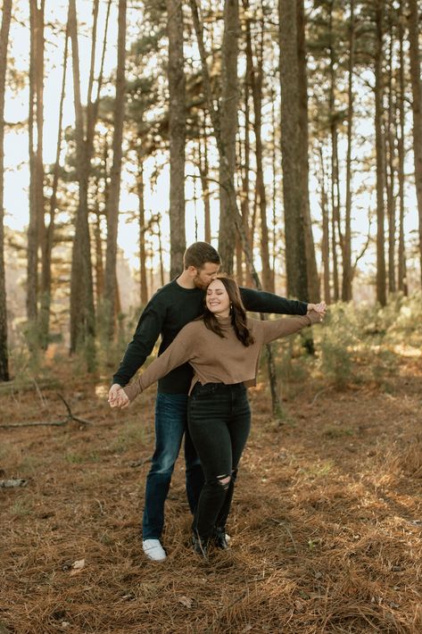 Green And Brown Couple Outfits, Trail Photoshoot Couple, Forest Engagement Shoot Outfit, Couple Poses In Woods, Woods Couple Pictures, Engagement Photos Outfits Forest, Couple Poses In Forest, Tree Engagement Pictures, Pine Tree Couple Photos