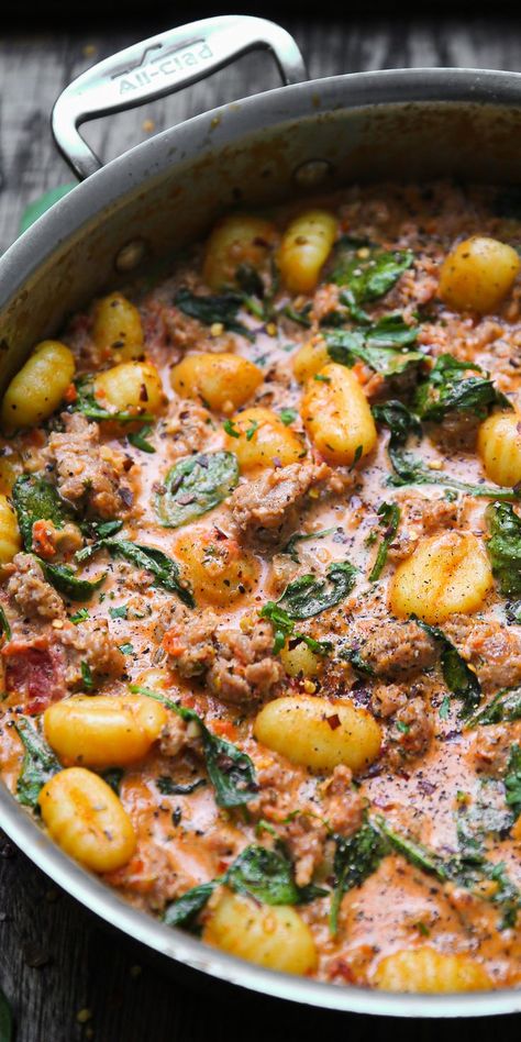 Creamy Italian Sausage Gnocchi with Spinach and Tomato Sauce in a stainless steel pan Gnocchi With Tomato Cream Sauce, Gnocchi Tomato Cream Sauce, Jamie Oliver Recipes 30 Minute Meals, Tuscan Sausage Gnocchi, Tuscan Sausage, Sausage Gnocchi, Pasta Sausage, Gnocchi Dishes, Spinach Sauce