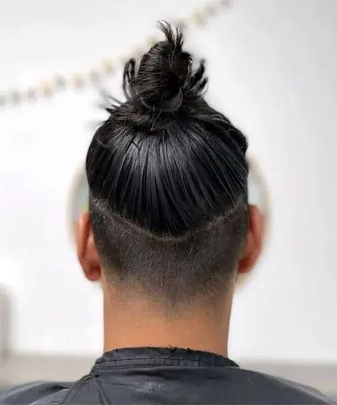 Glossy High Bun with Undercut. This trendy men’s hairstyle can be a cool choice for anyone wanting a fashionable aesthetic with modern edge. Man Bun Undercut Fade, Bun With Undercut, Long Undercut Men, Mens Long Hair Undercut, Top Knot Hairstyle, Man Bun Top Knot, Man Bun Haircut, Man Bun Undercut, Man Bun Styles