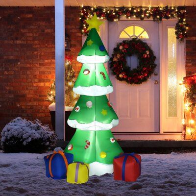 Create the ultimate festive Christmas display in your yard this holiday season with Christmas tree decorations. Designed with water-resistant polyester cloth and features an internal LED light, this outdoor inflatable will invoke the holiday spirit for years to come. Automatically inflating after power-on creates a super simple setup process that anyone can do. Build the perfect holiday yard display this year to outdo the neighbors and bring holiday cheer in classic Christmas fashion. | The Holi Blow Up Santa, Inflatable Christmas Decorations Outdoor, Inflatable Christmas Tree, Inflatable Christmas Decorations, Led Christmas Tree Lights, Storing Christmas Decorations, Christmas Tree With Presents, Christmas Tree And Santa, Christmas Yard Decorations