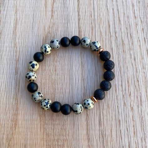 "This bracelet features stunning Dalmatian Jasper & matte Black Onyx gemstones, lava stones, and rose gold accent beads. Made with high quality elastic cord. Beads are 8mm, which are slightly larger than the size of a pea.  *To use as a diffuser bracelet, apply a drop or two of 100% pure essential oil to the lava stones. The scent will last for 1-2 days.  Dalmatian Jasper Healing Properties: Playfulness, Devotion, Releases Negativity Black Onyx Healing Properties: Calming, Grounding, Happiness L Dalmatian Beads Bracelets, Lava Bead Bracelet Ideas, Dalmatian Jasper Bracelet, Healing Beads, Lava Rock Bracelet, Lava Bead Bracelet, Aromatherapy Bracelet, Lava Stone Bracelet, Oil Diffuser Bracelet