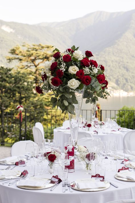 Tall Transparent vases topped with red and white roses, gypsophila and a touch of greenery Red And Gold Sweetheart Table, Wedding Decoration Red And White, Trumpet Centerpiece Wedding, Red Sage And White Wedding, Red White And Rose Gold Wedding, White And Red Wedding Centerpieces, Elegant Red Wedding Theme, Elegant Wedding Red Roses, Red Rose Wedding Reception Decor