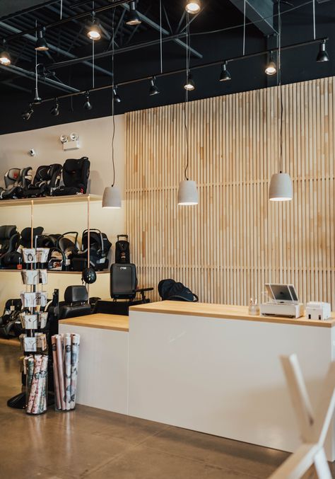 Feature wall behind the register. Lots of modern lighting. Retail Counter, Exposed Ceilings, Feature Wall Design, Retail Store Interior Design, Store Counter, Retail Lighting, Retail Interior Design, Retail Store Interior, Store Interiors