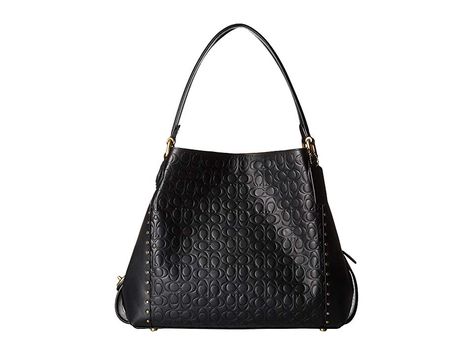 COACH Edie 31 Shoulder Bag in Signature Leather (B4/Black) Shoulder Handbags. Please Note: COACH items cannot be shipped to military addresses (APO or FPO) and addresses in Hawaii  the Virgin Islands  Guam or any other locations outside of the continental US. Edie combines downtown ease with utility. The soft  slouchy silhouette features a three-compartment interior designed for perfect organization. It's crafted of Signature  #COACH #BagsandLuggage #Handbag #Shoulder #Black Perfect Organization, Coach Edie, The Virgin Islands, Virgin Islands, Sneakers Boots, Free Clothes, Shoulder Handbags, Wallet Case, Wallets