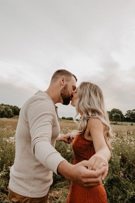 Orange Dress Couple Outfit, Rust Engagement Pictures, Burnt Orange Engagement Photos, Rust Orange Dress, Spring Engagement Photos Outfits, Field Engagement Photos, Engagement Photo Outfit, Engagement Shoot Outfit, Engagement Images