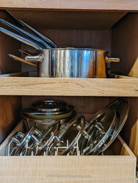 vertical dividers are great for pot lids Organize Pot Lids In Drawer, Pot Lids In Drawer, Lid Organizer Kitchen, Pot Organization Inside Cabinets, Pot Lid Storage Ideas, Storing Pot Lids, Pot Lid Storage, Water Bottle Organization, Cookware Storage