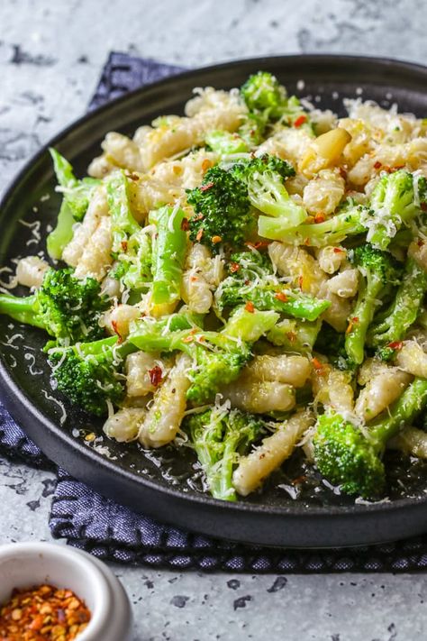 Learn how easy it is to make homemade cavatelli from scratch. This popular Italian pasta and broccoli dish is served with a simple sauté of olive oil, smashed garlic cloves and red chilli flakes. Garlic And Oil Pasta With Broccoli, Pasta Broccoli Garlic And Oil, Olive Oil Pasta With Veggies, Cork Screw Pasta Recipes, Homemade Cavatelli, Cavatelli And Broccoli, Garlic Olive Oil Pasta, Cavatelli Recipe, Pasta And Broccoli