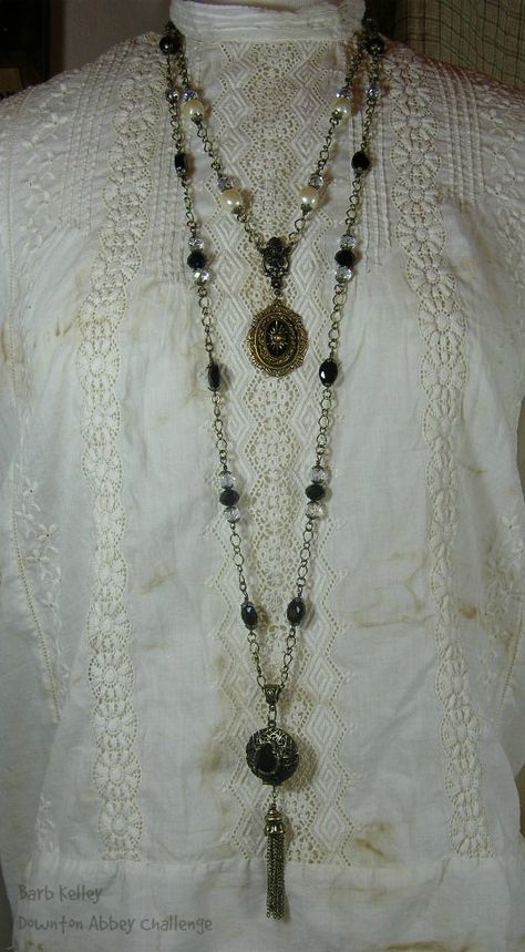 A long necklace is inspired by PBS's Downton Abbey.  It boasts vintage black glass beads and AB crystal beads with a vintage locket and tassel pendant.  The shorter necklace has matching AB crystals and vintage faux pearls.  The focal has a vintage glass cabochon with gold starburst design on a Victorian style brass ox bezel.  Thank you B'sue for the oldies but goodies! 1920s Tassel Necklace, Long Vintage Necklace, Long Necklaces Aesthetic, Vintage Long Necklace, Historical Clothes, Vintage Locket, Witch Necklace, Gold Starburst, Starburst Design