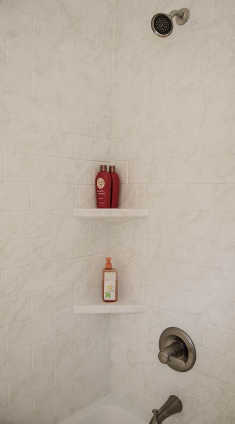 This built in corner shelf makes finding and using toiletries easy!   Plus who doesn't love new tile! Corner Shelf Tile Shower, Bath Corner Shelf, Shower Shelf Corner, Tile Shelves In Shower Built Ins, Shower Toe Shelf, Floating Shelf In Shower Wall, Tiled Shower Shelf, Shower Floating Shelf, Corner Shelf In Shower