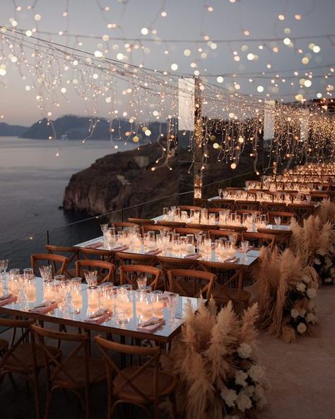 Julia & Evita on Instagram: "December 1st & it’s the perfect time to share with you the day we covered the entire balcony of Cavo Ventus with fairy lights, for Carina & Simon’s reception dinner 💛✨ Only with our favourite @whiteonblackstudio 😍 . . . #santoriniwedding #weddinginsantorini #greecewedding #weddingingreece #greeceweddingplanner #fairylights #fairylightsdecor #pampas #pampasgrass #pampasgrasswedding #summerwedding #weddingmoments" Fairy Lights Wedding Reception, Garden Wedding Reception Outdoor, Wedding Reception Outdoor, Luxury Event Decor, Fairy Lights Wedding, Wedding Reception Lighting, Dream Wedding Reception, Rustic Garden Wedding, Lights Wedding Decor