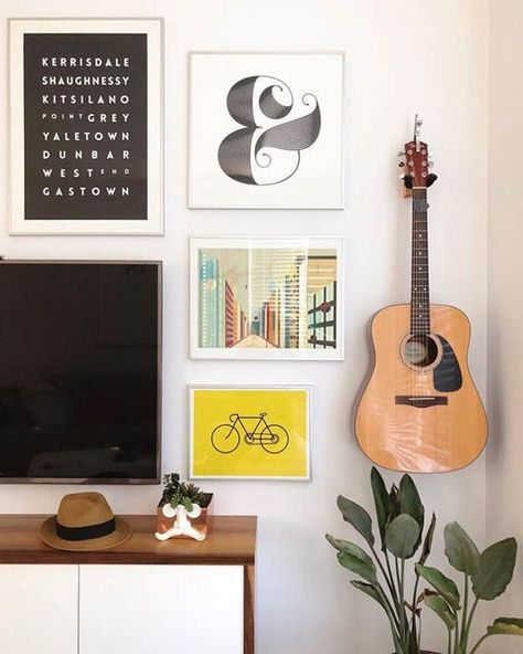 35 Simple Guitar Wall Display Ideas For Music Lovers | HomeMydesign | HomeMydesign Hang Guitar On Wall Ideas, Guitar Hanging On Wall, Hanging Guitars On Wall Ideas, Hang Guitar On Wall, Guitar On Wall, Guitars On The Wall, Guitar Hanging Ideas, Guitar Room Decor, Guitar Corner