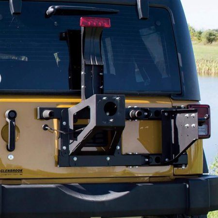 The MORryde Heavy Duty Secure Spare Tire Carrier is just what you need to mount a heavy spare on your Jeep Wrangler JK. Ensure your spare tire is safe and secure on the back of your vehicle by making sure you have a reliable mount. This versatile carrier can either mount onto a factory tailgate or you can pair it with MORryde's tailgate reinforcement kit (sold separately) for boosted tailgate strength. This piece of equipment helps maintain brake light visibility thanks to an included adjustable Tacoma Accessories, Accessoires 4x4, Spare Tire Mount, Trailer Tires, Camper Parts, Jeep Wrangler Jk, Adjustable Lighting, Wrangler Jk, Vehicle Design