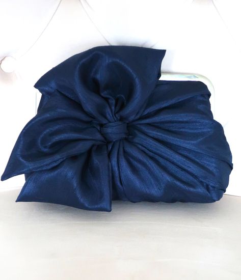 "Navy Bow Clutch, Bridal Accessories, Bridal Clutch, Bridesmaid Clutch, Clutch Purse, Something Blue An original Lost in Time design made in navy with a white lining. This stunning clutch is labour intensive to create. The bow section of the clutch is three separate pieces, machine and hand sewn to create a full bodied look. The resulting clutch is elegant and creates a substantial \"feel\" in your hand. This clutch must be seen to be fully appreciated. You may choose a different colour for your Navy Clutch Bag, Navy Blue Clutch, Navy Clutch, Navy Blue Purse, Bridesmaid Clutch, Bow Clutch, Lost In Time, Bridesmaid Clutches, Prom 2024