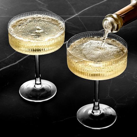 Ribbed vertical bands accentuate the modern, linear silhouette of our mouth-blown glassware. With their wide bowls and straight edges, these expertly crafted coupe glasses are ideal for serving sparkling wine and classic cocktails. Each one features a faceted design that brilliantly reflects the light to showcase your favorite beverages. Sold individually or as set of 4. Crafted of mouth-blown, fire-polished glass. Faceted exterior with smooth interior. Coordinates with other pieces in our Moder Coup Glasses Cocktails, Hammered Glassware, Nice Wine Glasses, Coup Glasses, Fancy Wine Glasses, Modern Glassware, Elegant Wine Glasses, Vintage Cocktail Glasses, Fun Wine Glasses