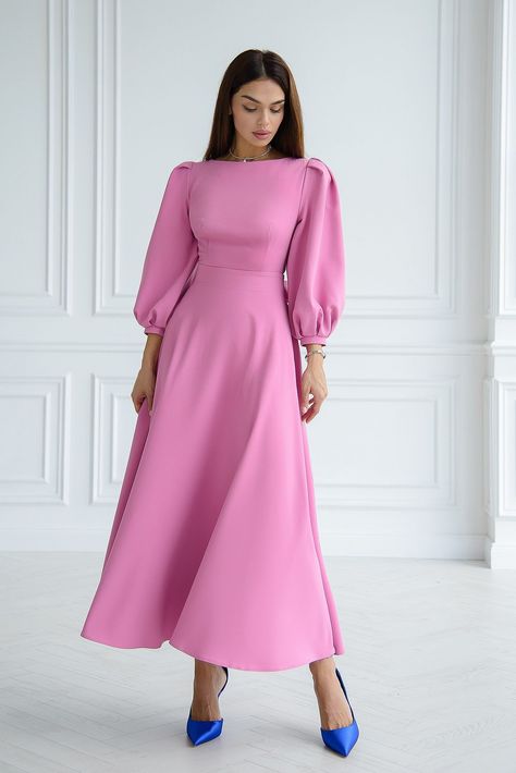 Emanate an air of enchanting grace in ELAGIA's Dusty-Pink Backless Puff Sleeve Midi Dress, a vision of loveliness and allure. The soft, romantic hue combined with the charming puff sleeves and an alluring backless design creates an ensemble that embodies feminine elegance. This dress is a delightful symphony of charm, perfect for exuding an irresistible, lovely allure. #dustypinkdress #puffsleeves #backlessdesign #feminineelegance #romanticensemble #lovelylook #womensfashion Pink Modest Dress, Modest Pink Dress, Dusty Pink Outfits, Satin Pink Dress, Soft Pink Dress, Modest Midi Dress, Dusty Pink Dresses, Satin Formal Dress, Wedding Dress Outfit