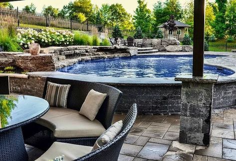 A semi above-ground pool is a hybrid between an above-ground pool and an in-ground pool. It's a pool that is only partially above ground with a small wall. Semi Above Ground Pool, Prefab Walls, Aboveground Pool, Backyard Spa, Oval Pool, Relaxing Pool, Raised Patio, Stock Tank Pool, Tank Pool