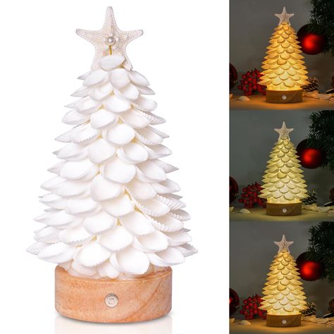 PRICES MAY VARY. 🎄Beautiful Sea Shell Christmas Tree: This is a carefully handmade LED shell Christmas tree that emits warm light at night, bringing you a wonderful visual effect. Dimensions: Approximately 8.6x5x5 inches, perfect for Christmas decorations. 🎄Unique Artistic Design: This is a perfect Christmas decorative art piece, handmade from natural shells, and decorated with natural starfish, small shells and artificial pearls, with a strong ocean flavor. 🎄Scope of Application: You can pla Island Christmas Decor, Shell Nativity, Christmas Tree Handmade, Led Christmas Tree Lights, Christmas Beach, Tree Statues, Tree Handmade, Decoration Party, Mini Christmas Tree