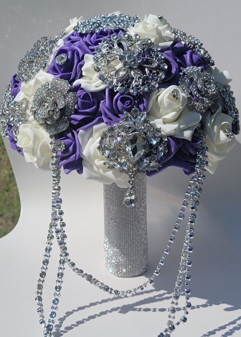 Foam Roses Brooch Bouquet is made up with ivory, purple roses, which will last long and will never fade. Its even more stunning and beautiful in person. This Luxury Brooch  Bouquet is approx 8 inches wide, brooches in multi sizes.  Handle wrapped in silver rhinestones. Royal Purple And White Wedding, Purple White Silver Wedding, Purple Flower Bouquet Wedding, Quince Flowers, Silver Bouquet, White Silver Wedding, Roses Bouquet Gift, Purple And Silver Wedding, Rocky Mount Nc