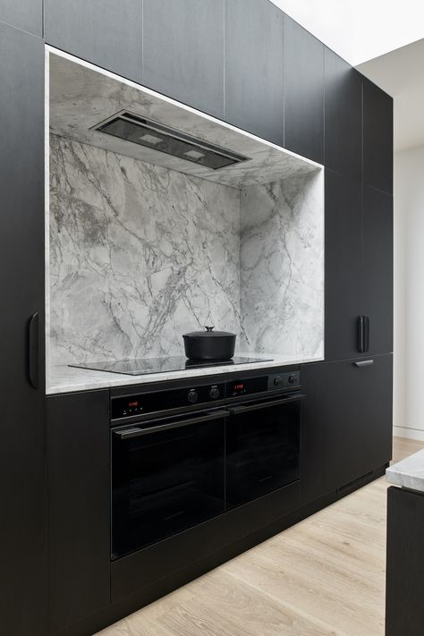 In this close up of the black kitchen, we see the black cabinetry, black joinery, marble splashback and black oven and black stove. From a deteriorating 1880's Victorian terrace home to a 21st century marvel, this home is a mix of contemporary style with heritage elements. To find out more about this heritage listed home, click on the pin or go to stylecurator.com.au. Terrace House Renovation, Contemporary Terrace, Timber Outdoor Furniture, Park Project, Tile Cladding, Diy Blinds, Albert Park, Stone Kitchen, Kitchen Marble