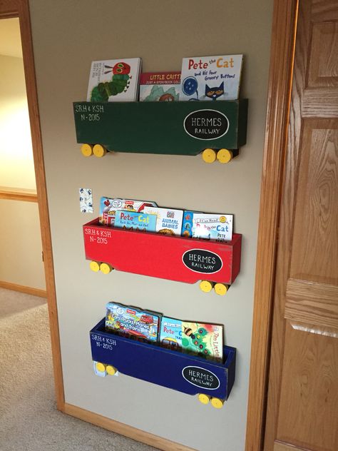 Train box car book shelves. I followed the instructions from the link below. I did use a different paint. I also customized the letters for our family name and the date since my little guy was born in Nov of 2015.   https://www.pinterest.com/pin/447052700489929870/ Train Box Car, Car Book, Name Decor, Train Room, Pete The Cat, Book Shelves, Train Set, Box Car, Diy Shelves