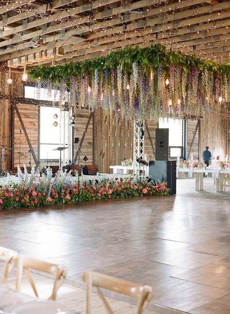 Blue, lavender, purple, pink delphinium ceiling installation chandelier Dance Floor Flower Installation, Floral Roof Installation Wedding, Dance Floor Chandelier, Wedding Ceiling Installation, Ceiling Installation Wedding, Floral Ceiling Wedding, Ceiling Floral Installation, Wisteria Ceiling, Blue Delphinium Wedding