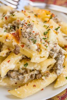 Three Cheese Italian Sausage Alfredo Bake - great make-ahead pasta dish. Elbow macaroni, alfredo sauce, sour cream, ricotta, garlic, italian sausage, eggs, parmesan and mozzarella cheese. SO good!! We make this at least once a month! Can freeze half for later. This is THE BEST pasta casserole we've ever eaten!!! #casserole #freezermeal #pasta #pastacasserole Italian Sausage Alfredo, Sausage Alfredo Bake, Ground Italian Sausage Recipes, Baked Pasta Casserole, Sausage Alfredo, Alfredo Bake, Italian Sausages, Italian Sausage Recipes, Sausage Dishes