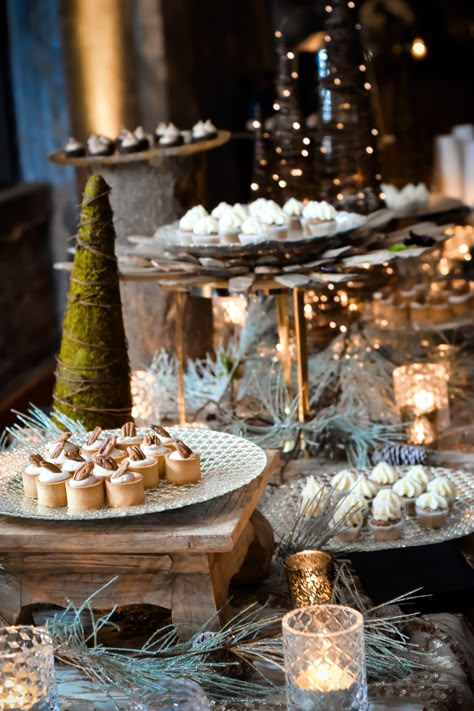 Need to spice up a dessert table for a winter wedding? Displaying candles, miniature trees, wooden accents, and frosted pine branches creates a beautiful, wintry dessert table! | Pretty + Planned Events | Visit prettyandplanned.com today to start the wedding planning process. Together, we can plan something pretty! | Photographer: Picture this Studio | Winter Wedding Food Stations, Winter Dinner Decorations, Dessert Table Ideas Christmas, Christmas Wedding Appetizers, Winter Buffet Table Decor, Christmas Dinner Buffet Table, Dessert Table Aesthetic, Christmas Food Display, Winter Wedding Dessert Table