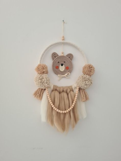 Neutral nursery wall hanging decor with teddy bear in brown, beige and ivory colours, macrame cute teddy's head  and with fluffly pompoms, felt, tassels and beads chain.  Perfect dream catcher or door sign for girl, boy nursery or toddlers bedroom. It fit with our Teddy bear ceiling lamp available on the listinig below: https://www.etsy.com/uk/listing/1472958947/neutral-colours-nursery-lampshade This unique neutral wall hanging decor will add beautiful and modern touch and fit to little kids, ne Bedroom Handmade Decoration, Macrame For Kids, Macrame Kids Room, Baby Door Decorations, Nursery Lampshade, Nursery Dream Catcher, Toddlers Bedroom, Dream Catcher For Kids, Toddler Playroom