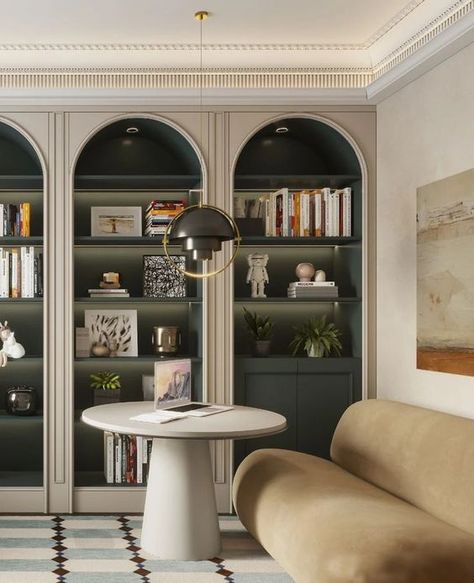 Picture of a sophisticated space with arched bookcases, dark green shelves and cabinets, books and lovely decor, a tan sofa and a round coffee table Green Arched Bookcase, Arched Library, Arched Kitchen Cabinets, Book Shelves Ideas, Arch Shelves, Arched Bookcases, Arched Shelving, Arch Bookcase, Round Bookshelf