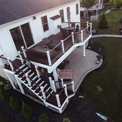 One of the challenges we come across often as we design walkout elevated decks is the column/post placement. It’s never appealing to have a window or door looking out at a column. This deck would typically have a minimum of 3 posts, but since we kept the design simple, we were able to make the 20’ span with just 2 posts by upgrading to an engineered beam. The result is an unobstructed view from the walk-out basement.  With a purposely simple design, it’s the details and finishes that bring t... Patio Under Decks, Deck Remodel, Deck And Patio, Backyard Patio Deck, Deck Pictures, Building A Porch, Patio Deck Designs, Cozy Backyard, Deck Designs Backyard