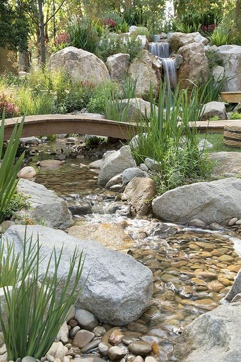 The greatest rain garden design idea is to incorporate a waterfall and pond. This will look good if you have a spacious backyard. It will help in creating a place where you relax amongst nature.#raingarden #gardendesign   #gardendesignideas #gardendesignideasonabudget Rain Garden Design, Garden Landscaping Design Ideas, Waterfall Landscaping, Garden Stream, Taman Air, Garden Waterfall, Pond Landscaping, Backyard Water Feature, Waterfalls Backyard