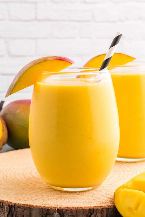 This delicious Mango Lassi recipe makes a refreshing drink with simple ingredients in just 10 minutes, perfect for hot summer days! With a blend of yogurt, sweet mangoes, fresh mango juice, honey, cardamom, vanilla, and ice, this tropical beverage is packed with delicious fruity flavor! #mangoes #lassi #mangolassi #beverage #drink #mangolassirecipe Best Mango Lassi Recipe, Homemade Punch, Mango Lassi Recipe, Strawberry Lassi, Mango Lassi Recipes, Lassi Recipe, Almond Milk Yogurt, Lassi Recipes, Mango Drinks