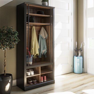 Bring storage and organization to your entryway, laundry room, or mudroom with this industrial-inspired hall tree. It's crafted from engineered wood in a two-toned black and walnut hue that adds a mixed-materials look we love. Its vertical silhouette houses four open cubbies on the base that are great for tucking away shoes or bags, with a bench right above that's ideal for taking off your shoes. A row of three coat hooks keeps jackets, scarves, purses, and hats easily accessible, while two addi Entryway Laundry Room, Bench Shoe Storage, Bench And Shoe Storage, Hall Tree With Bench, Entryway Laundry, Black And Walnut, Storage Cubbies, Entryway Hall Tree, Entryway Hall