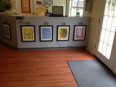 Simple frames highlight and honor children's open-ended artwork in Sunshine House 91's lobby in Marietta, GA Childcare Front Entrance Ideas, Childcare Lobby Ideas, Daycare Director Office Ideas, Childcare Center Lobby, Daycare Lobby Ideas Reception Areas, Childcare Director Office Decor, Childcare Director Office, Preschool Lobby Decor Ideas, Preschool Director Office