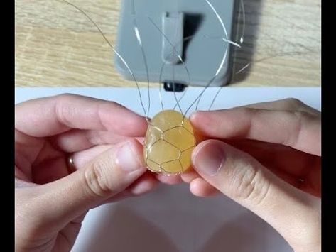 How to wire wrap a round tumbled stone - YouTube Wire Wrapping Circle Stones, How To Make A Stone Into A Necklace, How To Wire Wrap Tumbled Stones, Polished Rock Jewelry Diy, How To Wrap A Palm Stone, How To Wire Wrap A Round Stone, Cord Wrapped Stones Diy, Wire Wrapped Round Stone, How To Wrap A Rock With Wire