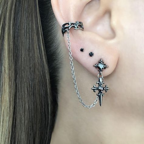 LISTING FOR 1 PIECE ONLY Gothic inspired Cross earring is attached with a chain to the Ear cuff.  Cuff part of the earring needs no piercing, just slide on the ear. This cuff fits both right and left ears.  Material:316 Stainless steel/ set with Black Cubic Zirconia stones Total earring length"  3 1/2"  Cuff :5.5 mm Cross stud:  25 mm *RETURNS / REFUNDS * -If you would like to return you purchase , please contact us within 7 days of receiving your package and we will accept the return.Return wil Gothic Ear Piercings, Silver And Black Earrings, Ear Piercing Set Up, Goth Ear Piercings, Gothic Piercings, Alt Earrings, Mens Earring, Cross Earring, Ear Piercing Jewelry