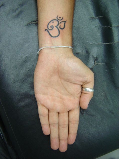 OM + ELEPHANT!!! tattoo. i could actually get something on that part of my wrist...if it is cool enough Aum Tattoo, Arabic Tattoos, Ganesh Tattoo, Yoga Tattoos, Ganesha Tattoo, Om Tattoo, Tasteful Tattoos, Elephant Tattoo, Lotus Tattoo