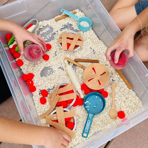 Looking for an easy Apple sensory bin for fall? This apple pie sensory bin for preschoolers is perfect! Little ones will enjoy scooping, pouring, and creating their own little pies! What fun! Check out this apple pie sensory table idea today. Apple Pie Sensory Bin, Apple Sensory Bin Preschool, Apple Sensory Bin, Sensory Bins For Preschool, Pie Sensory Bin, Sensory Bin For Preschoolers, Apple Sensory, Sensory Table Ideas, Harvest Activities