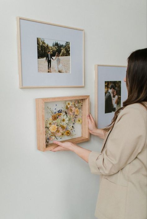 What better way to display your preserved wedding bouquet than next to printed photos from your wedding? Wedding Flower Frame Dried, Wall Of Wedding Photos, Printed Wedding Photos, Wedding Flowers Preservation, How To Display Engagement Pictures, Framed Wedding Flowers, Preserve Bouquet Wedding, Wedding Photo Prints On Wall, Wedding Photos Framed Wall Display Ideas