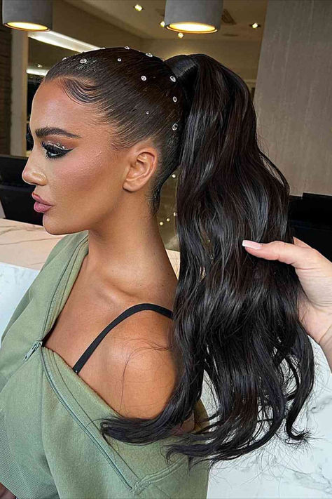 Image of a wavy ponytail upstyle adorned with hair gems, perfect for adding glamour to summer nights. Slick Back Ponytail With Gems, Christmas Dance Hairstyles, Wedding Glam Hair, Slick Hair With Gems, Ponytail With Gems, Slick Back Hair With Pearls, Hair Styles With Gems, Straight Hair Homecoming Styles, Winterball Hair