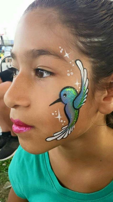 Hummingbird Face Painting. Rainbow Face Paint, Animal Face Paintings, Festival Face Paint, Face Painting Tips, Cheek Art, Girl Face Painting, Face Painting Tutorials, Rainbow Face, Festival Face