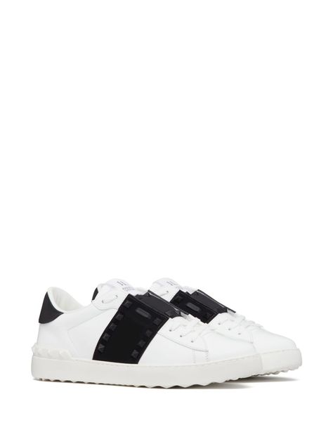 Find VALENTINO Rockstud Untitled Leather Sneakers on Editorialist. Rockstud Untitled leather sneakers from Valentino Garavani featuring white/black, calf-length, signature Rockstud detailing, logo patch at the tongue, front lace-up fastening, round toe and flat rubber sole. Heel 1 in / 2,5 cm; Platform 0,8 in / 2 cm Valentino Garavani Sneakers, Valentino Sneakers, Sporty Outfit, Sneaker Design, Detailing Logo, Valentino Black, Valentino Rockstud, Sneakers For Women, Leather Cap