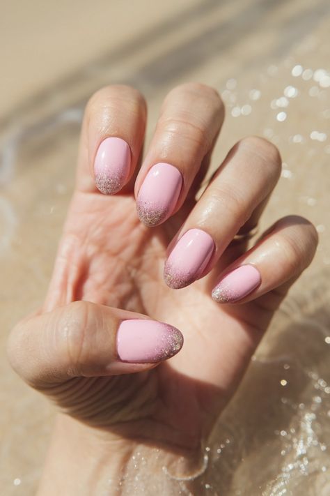 Elevate your nail game with these stunning soft round pink nails, perfect for a light summer look. The blend of high gloss and subtle glitter on this design creates a soft yet eye-catching effect. Whether you opt for natural nails or gel extensions, these pink nails are sure to make a statement. Add a few rhinestones for that hot touch of sparkle, and you've got the ultimate nail art idea to flaunt all season long! #PinkNails #NailArt #SummerNails #GelNails #Sparkle Round Pink Nails, Nail Art Idea, Gel Extensions, Art Idea, Nail Games, Light Summer, Summer Look, Natural Nails, Pink Nails