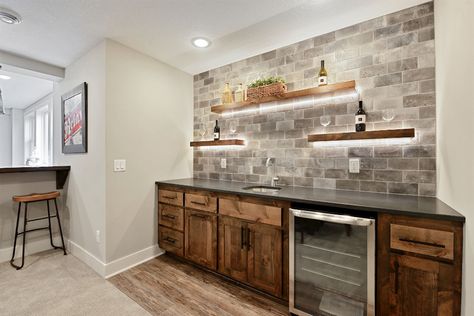 Wet Bars Photo Gallery | TJB Homes Wet Bar With Floating Shelves, Bar Shelves Ideas, Bar With Floating Shelves, 3 Floating Shelves, Billiards Room Decor, Rustic Basement Bar, Basement Wet Bar, Pool Table Room, Rustic Basement