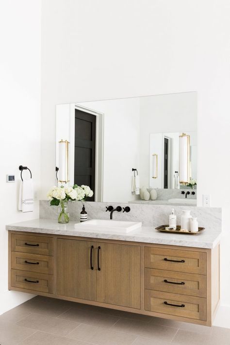 Floating vanities have a cool modern look and are perfect for aging in place clients. This beautiful vanity was designed by Studio McGee. #bathroom #bathroomideas #bathroomdesign Floating Vanity Bathroom, Modern Bathroom Mirrors, Bilik Air, Bathroom Vanity Designs, Traditional Bathroom Vanity, House Of Turquoise, Vanity Design, Double Sink Bathroom, Floating Vanity